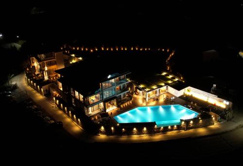 an aerial view of a building with a swimming pool at night at XMAN Sunrise Peaks Resort--Free Pick-up in Zhangjiajie