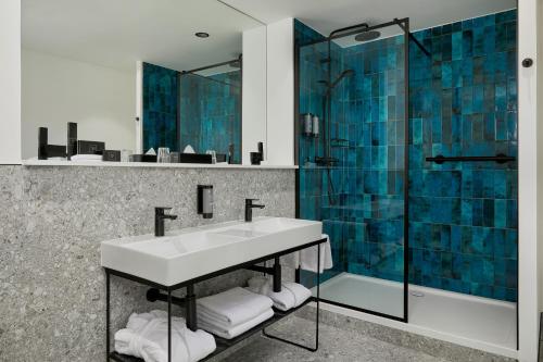 a bathroom with a sink and a glass shower at Waterford Marina Hotel in Waterford