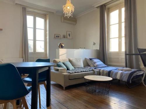 sala de estar con sofá y mesa en #Le Maitre du Navire - Grand Studio - Hyper centre en Brive-la-Gaillarde