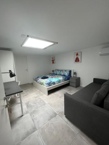 a living room with a bed and a couch at Lucullo's Rooftop in Naples