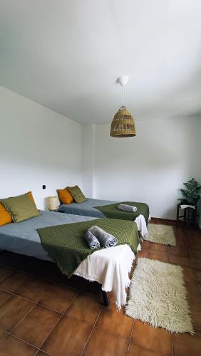 a bedroom with two beds and a pendant light at Villa Moiko in La Parra