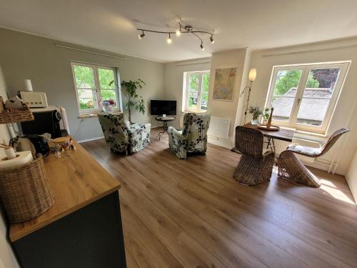 a living room with a table and chairs at B&B Villa Giethoorn - canalview, privacy & parking in Giethoorn