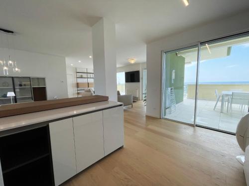 a kitchen and living room with a view of the ocean at Gli Scogli Luxury Residence Hotel in Chiavari