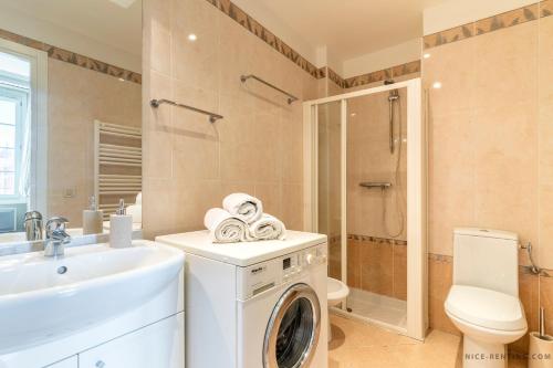 a bathroom with a washing machine and a sink at Nice Renting - 13 MASSENA - Live A Dream Luxury Loft - Place Massena in Nice