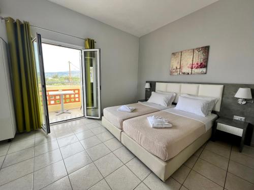 a bedroom with a bed and a large window at Maria Hotel Sisi in Sissi