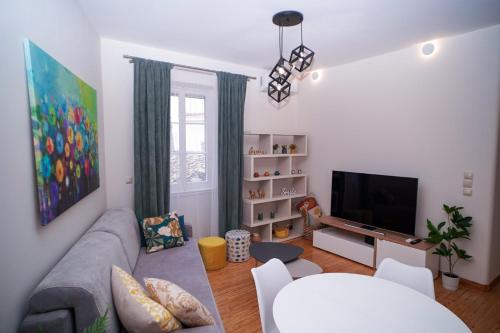 a living room with a couch and a television at Casa nella Fortezza in Corfu