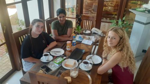 a group of people sitting around a table at Ever Green Villa in Negombo