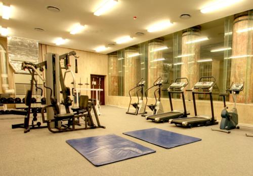 a gym with treadmills and ellipticals in a room at Cape Eazi Stayz Mutual Apartments in Cape Town