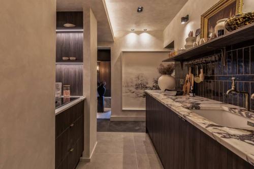 a large kitchen with a sink and a tub at Alfred's Ramsbottom - Suite One in Ramsbottom