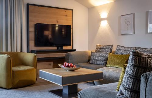 a living room with two couches and a tv at Hotel Franks in Oberstdorf