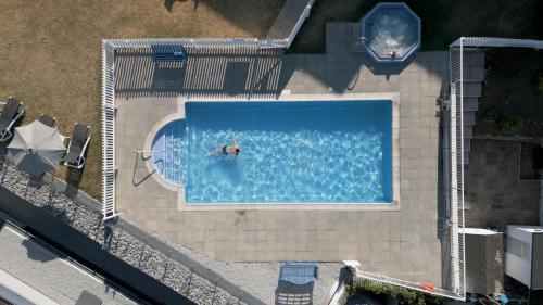 an overhead view of a swimming pool with a person in it at Lincombe Hall Hotel & Spa - Just for Adults in Torquay