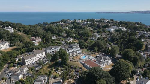 an aerial view of a town with houses and the water at Lincombe Hall Hotel & Spa - Just for Adults in Torquay