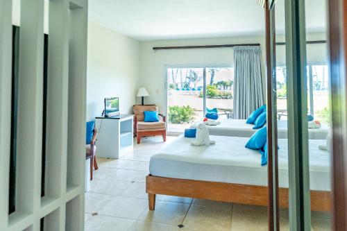a bedroom with two beds and a window at Agualina Kite Hotel Oceanfront Apartments in Cabarete