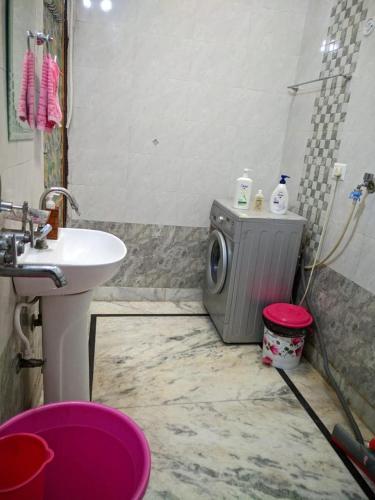 a bathroom with a washing machine and a sink at Kridha holidays homestay with kitchen in Vrindāvan