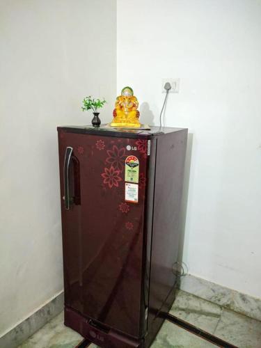a brown refrigerator with a statue on top of it at Kridha holidays homestay with kitchen in Vrindāvan