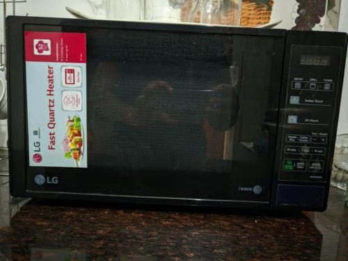 a microwave oven sitting on top of a counter at Kridha holidays homestay with kitchen in Vrindāvan