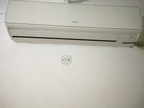 a computer monitor sitting on top of a refrigerator at Kridha holidays homestay with kitchen in Vrindāvan