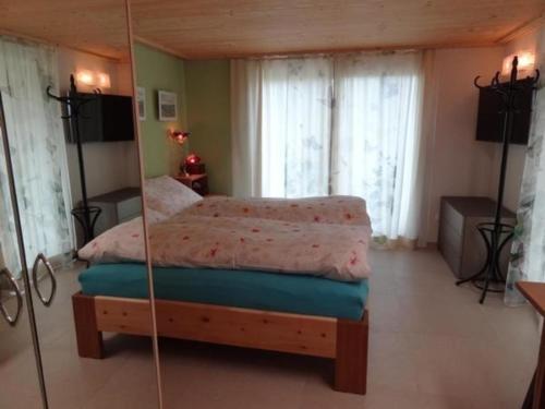 a bedroom with a bed and a mirror at Haus am Sternsberg in Sternenberg