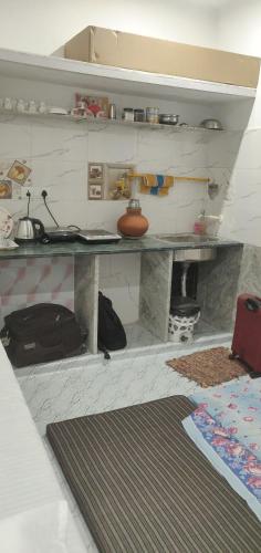 a living room with a table and a rug at Kridha holidays homestay with kitchen in Vrindāvan