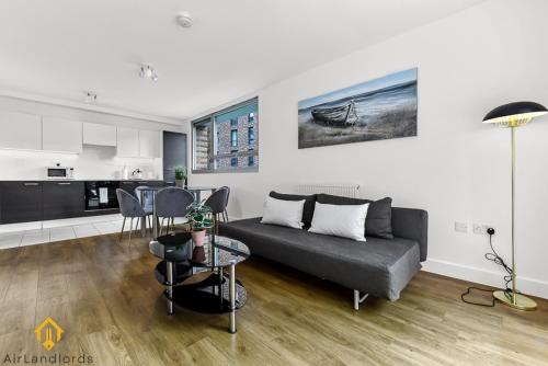 a living room with a couch and a table at Exclusive 3 bed 3bath Penthouse near Canary Wharf in London