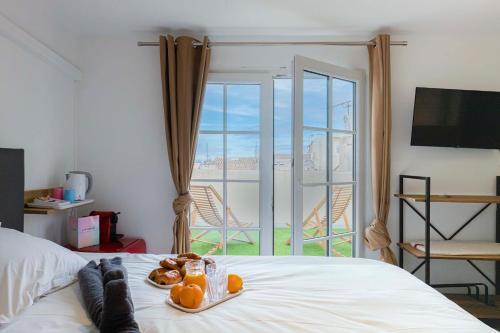 a bedroom with a bed with a view of a balcony at Villa Sibille - Plein centre de Saint-Tropez in Saint-Tropez