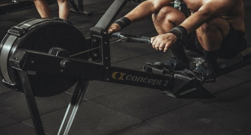 a man sitting on a machine in a gym at Tsala Treetop Lodge in Plettenberg Bay
