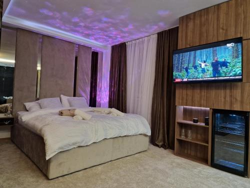 a bedroom with a bed with a teddy bear on it at PETKOV5KI.LuxuryApartments in Skopje