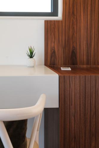 a white desk with a plant sitting on top of it at Bed&Belvedere in Otranto