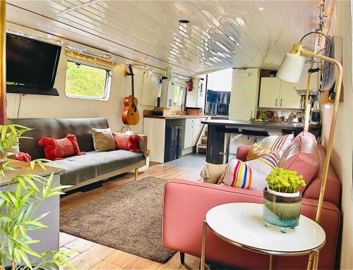 a living room with a couch and a table at Boutique Boat Stays in Bath