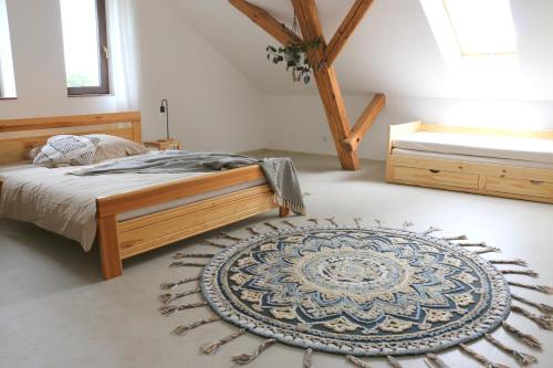 a bedroom with a bed and a rug on the floor at Usedlost Horka Onšov in Onšov
