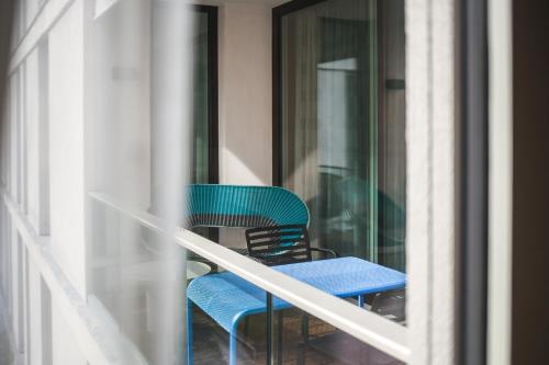 a blue table and chairs on a balcony at The Circus Apartments in Berlin