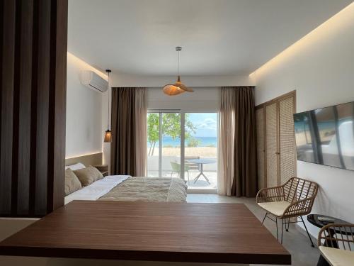 a bedroom with a bed and a view of the ocean at Penthouse & apartments by the Sea airport Airstay in Artemida