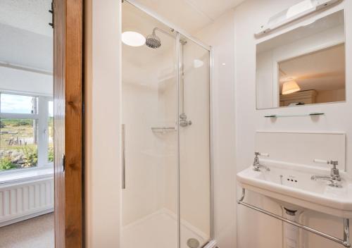a bathroom with a shower and a sink at 4 Zoar Cottage in Marytavy