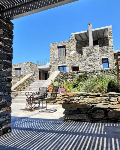 a stone building with a bench and a stone wall at Agrikea in Korissia