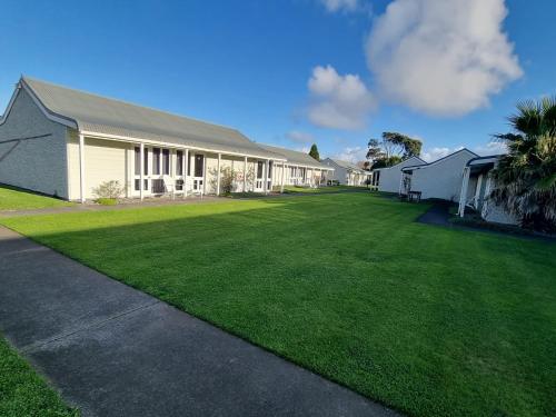 a house with a large lawn in front of it at The Furlong in Hawera
