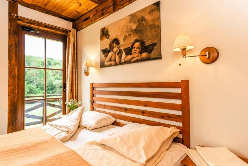 a bedroom with two beds and a window at Klumpes Malunas in Vosbutai