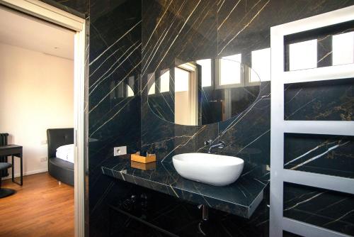 a bathroom with a sink and a mirror at Savoia Luxury Apartment in Milan