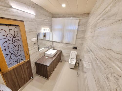 a bathroom with a sink and a mirror at Taha Inn Home comfort in Srinagar