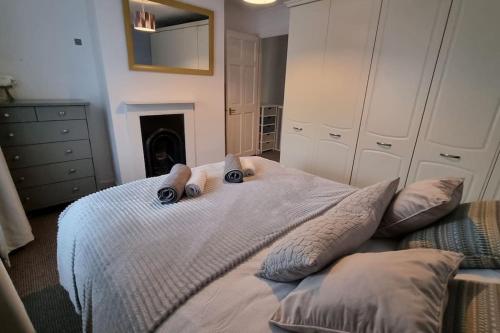 a bed with two teddy bears on top of it at Entire House With Garden & Parking Nr Ashford Int in Ashford