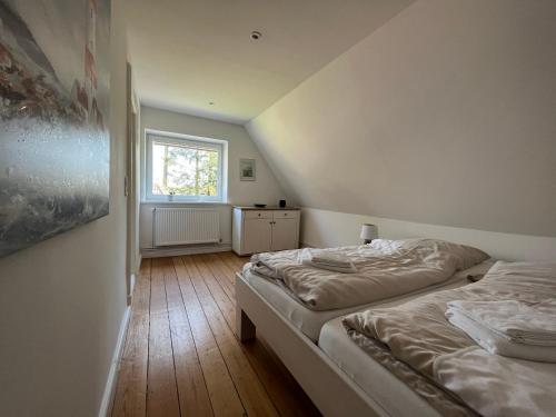 a bedroom with two beds and a window at Alte Schule Meyn in Meyn
