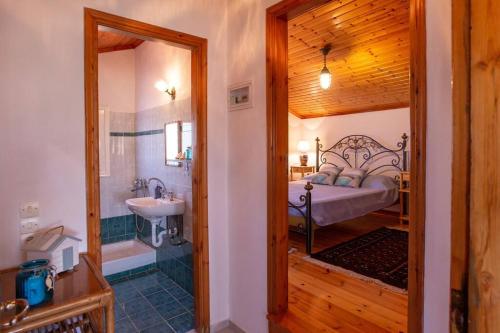 a bathroom with a bedroom with a bed and a sink at Sea Breeze Coastal House in Almyros Beach in Almiros Beach
