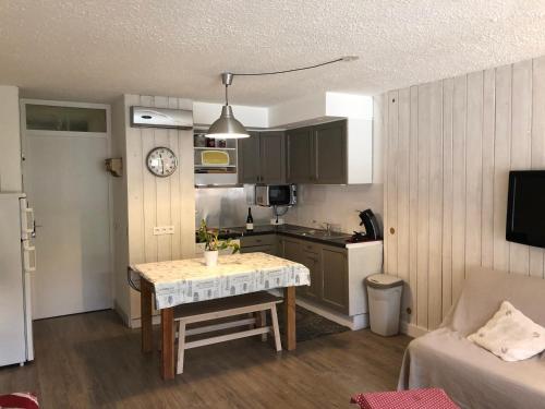une petite cuisine avec une table dans une pièce dans l'établissement Studio Lumineux à 250m des Pistes, Parking Privé, Balcon et Équipements Complets - FR-1-165A-134, à Uvernet