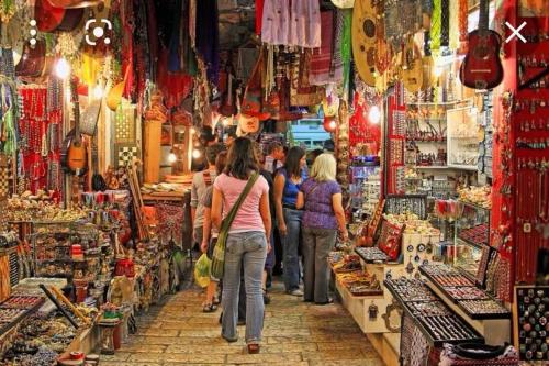 a group of people walking through a store in a market at Beautiful apartment in the center ofJerusalem 4 in Jerusalem