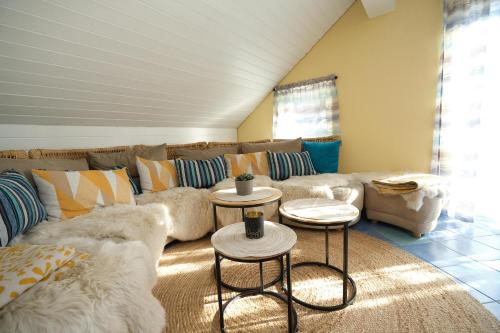 a living room with a couch and two tables at Santner, Hotel in Eugendorf