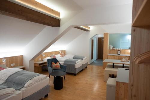a bedroom with a bed and a desk and a couch at Santner, Hotel in Eugendorf