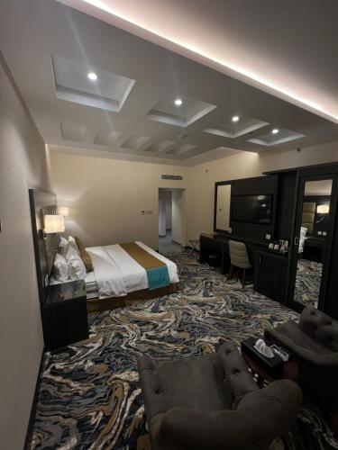 a hotel room with a bed and a television at W Platinum Hotel in Al Madinah