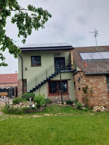 a house with solar panels on top of it at Apartmá U rybníčku in Dolní Dunajovice