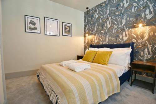 a bedroom with a bed with two towels on it at Quirky cottage set in Clitheroe in Clitheroe