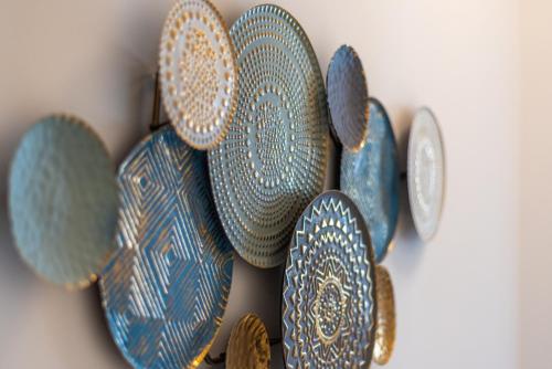 a group of plates hanging on a wall at Flying Bridge in Podstrana