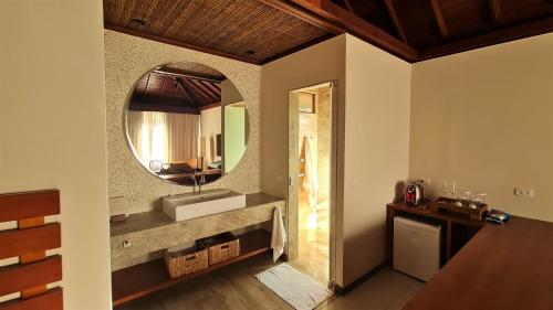 a bathroom with a sink and a mirror at NANNAI Noronha Solar Dos Ventos in Fernando de Noronha